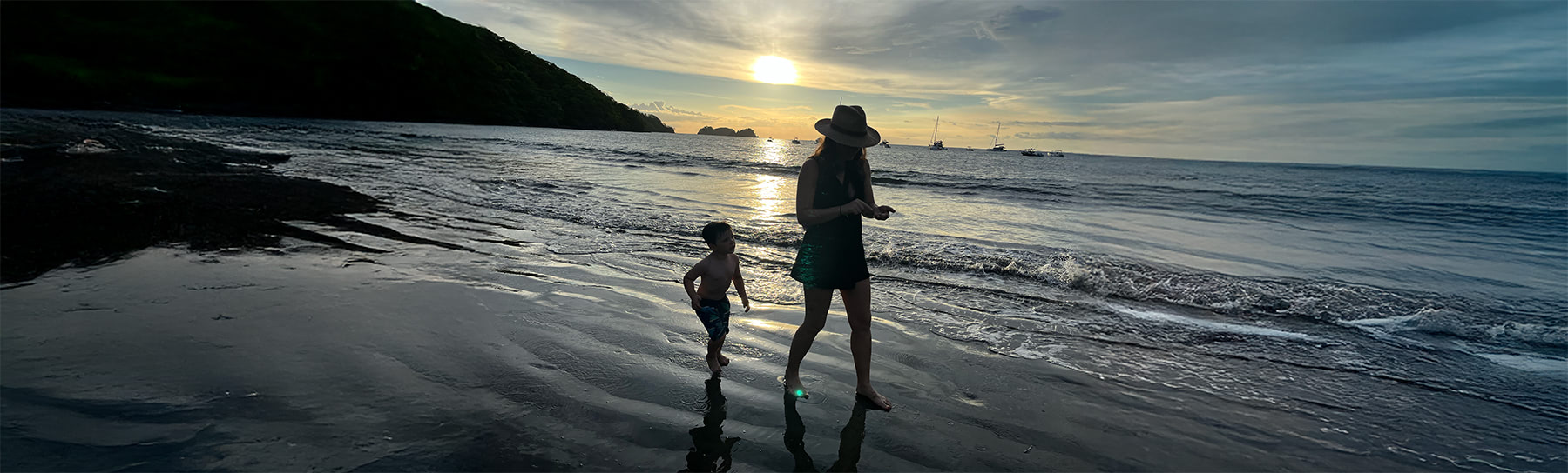 Mom and son walking on a beach